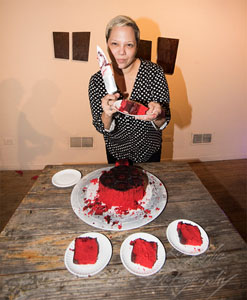 Edra Soto cutting cake. Photo by Rob Karlic